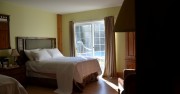 Large ground floor family sized room with two double beds, heated bathroom floor and walkout to poolside patio