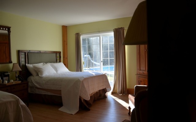 Large ground floor family sized room with two double beds, heated bathroom floor and walkout to poolside patio