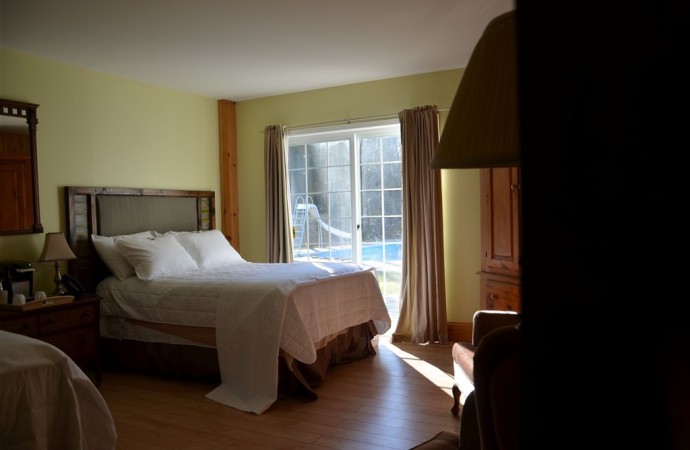 Large ground floor family sized room with two double beds, heated bathroom floor and walkout to poolside patio