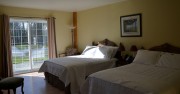 Large ground floor family sized room with two double beds, heated bathroom floor and walkout to poolside patio